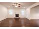 Spacious living room with hardwood floors, a brick fireplace, and a ceiling fan at 4305 Huron Dr, Cumming, GA 30028