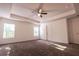 Large bedroom with tray ceiling, ceiling fan, and natural light with carpet flooring for a cozy atmosphere at 4305 Huron Dr, Cumming, GA 30028