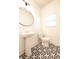 Stylish powder room featuring a pedestal sink, geometric tile flooring, and modern fixtures at 4305 Huron Dr, Cumming, GA 30028