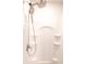 Close-up of walk-in shower stall with chrome fixtures and built in shelves for storage at 4305 Huron Dr, Cumming, GA 30028