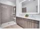 Modern bathroom with dual sink vanity and glass enclosed shower with tile walls at 775 Juniper Ne St # 327, Atlanta, GA 30308