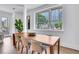Sunlit dining area with natural wood table and view of cityscape at 775 Juniper Ne St # 327, Atlanta, GA 30308