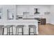 Well-lit kitchen featuring island with seating, stainless appliances, and sleek cabinets at 775 Juniper Ne St # 327, Atlanta, GA 30308