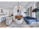 The well-lit living room with an open layout to kitchen features modern finishes and a cozy seating area at 775 Juniper Ne St # 327, Atlanta, GA 30308