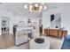 This open-plan living room features sleek white cabinets, contemporary lighting, and modern decor at 775 Juniper Ne St # 327, Atlanta, GA 30308