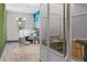 Modern office with green wall, work stations, and glass enclosed rooms at 775 Juniper Ne St # 327, Atlanta, GA 30308