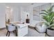 Modern office space features a sleek white desk, neutral decor, and view to the hallway at 775 Juniper Ne St # 327, Atlanta, GA 30308