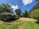 Expansive backyard with lush lawn and mature trees providing shade at 1272 Cave Springs Rd, Douglasville, GA 30134