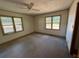 Bedroom with two large windows and carpeting at 1272 Cave Springs Rd, Douglasville, GA 30134