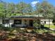 Charming single story home with covered porch, shutters, and mature trees at 1272 Cave Springs Rd, Douglasville, GA 30134