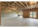 Unfinished basement with concrete floors, exposed ceilings, and natural light from backyard doors at 2996 Treeside Ter, Marietta, GA 30066