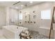 Spa-like bathroom with a soaking tub, a walk-in shower with multiple shower heads, and neutral tile throughout at 2996 Treeside Ter, Marietta, GA 30066