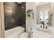 Bathroom features a tub with black subway tile, black hardware, and a modern vanity at 2996 Treeside Ter, Marietta, GA 30066