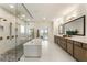 Luxurious bathroom featuring a freestanding tub, double vanity, and a walk-in shower with multiple shower heads at 2996 Treeside Ter, Marietta, GA 30066