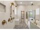 Elegant bathroom showcasing a rainfall shower head, a mosaic floor, and a luxurious soaking tub in the background at 2996 Treeside Ter, Marietta, GA 30066