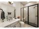 Bright bathroom featuring a walk-in shower with black framed glass doors and a white vanity with a modern faucet at 2996 Treeside Ter, Marietta, GA 30066