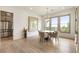 Dining area featuring large windows with scenic views, a modern chandelier, and convenient access to the kitchen at 2996 Treeside Ter, Marietta, GA 30066