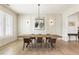 Elegant dining room featuring modern lighting, decorative wall paneling, and hardwood floors at 2996 Treeside Ter, Marietta, GA 30066