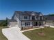 Beautiful home showcasing a three-car garage, a long driveway, and manicured landscaping at 2996 Treeside Ter, Marietta, GA 30066