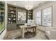 Well-lit home office featuring custom shelving, plantation shutters, and designer lighting at 2996 Treeside Ter, Marietta, GA 30066