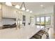 Bright kitchen featuring a large island with seating, modern appliances, and an adjacent breakfast nook with scenic views at 2996 Treeside Ter, Marietta, GA 30066