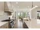 Well-lit kitchen with modern appliances, large island with bar seating, and an open dining area at 2996 Treeside Ter, Marietta, GA 30066