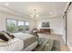Spacious main bedroom with tray ceilings, an ornate chandelier, and a large window framing views at 2996 Treeside Ter, Marietta, GA 30066