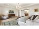 Airy main bedroom showcasing a tray ceiling, light hardwood floors, a decorative rug, and bathroom access at 2996 Treeside Ter, Marietta, GA 30066