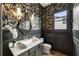 Stylish powder room featuring dark floral wallpaper, modern vanity, and elegant lighting for a sophisticated touch at 2996 Treeside Ter, Marietta, GA 30066
