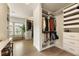 Bright walk-in closet with custom built-ins, natural light, and wood floors, creating a stylish dressing space at 2996 Treeside Ter, Marietta, GA 30066