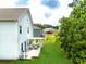Lovely backyard featuring a well-maintained lawn, privacy trees, and a covered deck at 3390 Meadow Grass Drive, Dacula, GA 30019