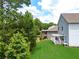A spacious backyard with a manicured lawn and a pergola-covered deck, perfect for outdoor gatherings at 3390 Meadow Grass Drive, Dacula, GA 30019