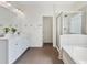 Bright bathroom featuring a tiled shower, soaking tub, and a white double vanity with marble countertop at 3390 Meadow Grass Drive, Dacula, GA 30019