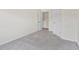 Carpeted bedroom with two doors, offering a simple and functional living space at 3390 Meadow Grass Drive, Dacula, GA 30019