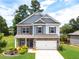 Charming two-story home with stone accents, lush landscaping, and a well-manicured front yard at 3390 Meadow Grass Drive, Dacula, GA 30019