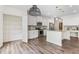 Modern kitchen featuring white cabinets, stainless steel appliances, granite countertops, and wood-look floors at 3390 Meadow Grass Drive, Dacula, GA 30019