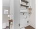 Laundry room with shelving, a white shiplap wall, and wooden-look flooring at 3390 Meadow Grass Drive, Dacula, GA 30019