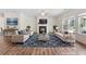 Staged living room showcasing a fireplace, plush seating, and ample natural light at 3390 Meadow Grass Drive, Dacula, GA 30019