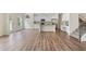 Open floor plan featuring hardwood floors, a modern kitchen, and a staircase at 3390 Meadow Grass Drive, Dacula, GA 30019