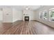 Bright living room with hardwood floors, a fireplace, and large windows at 3390 Meadow Grass Drive, Dacula, GA 30019