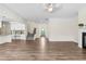 Open concept living area featuring hardwood floors, fireplace, and access to the modern kitchen at 3390 Meadow Grass Drive, Dacula, GA 30019