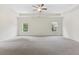 Spacious main bedroom features neutral carpet, large windows, tray ceiling, and a ceiling fan at 3390 Meadow Grass Drive, Dacula, GA 30019