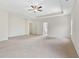Spacious main bedroom features neutral carpet, large windows, tray ceiling, and a ceiling fan at 3390 Meadow Grass Drive, Dacula, GA 30019