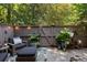 Cozy outdoor patio with comfortable seating, ambient lighting, and privacy fence at 46 Ivy Ne Rdg, Atlanta, GA 30342