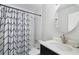 The clean bathroom features modern fixtures, a decorative curtain, a sink vanity, and a bathtub with a shower at 46 Ivy Ne Rdg, Atlanta, GA 30342