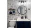 Chic powder room features decorative wallpaper, black fixtures, and modern vanity at 46 Ivy Ne Rdg, Atlanta, GA 30342