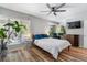 Bright bedroom with a ceiling fan, a TV set, and an accent sitting area near a window overlooking the outdoors at 46 Ivy Ne Rdg, Atlanta, GA 30342