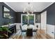 Stylish dining room with modern lighting, dark walls, and sliding glass doors at 46 Ivy Ne Rdg, Atlanta, GA 30342