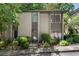 Two-story townhouse with neutral exterior, surrounded by mature trees and landscaping at 46 Ivy Ne Rdg, Atlanta, GA 30342