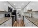 Updated kitchen features stainless steel appliances, granite countertops, and wood flooring at 46 Ivy Ne Rdg, Atlanta, GA 30342